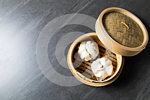 è‚‰ã¾ã‚“. steamed pork bun. Chinese Traditional cuisine concept. Dumplings Dim Sum in bamboo steamer with text copy space. Asian